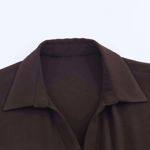 Close-up of the notched lapel and smooth dark brown fabric of this shirt dress