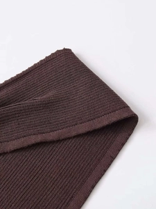 Detailed macro view of dark brown rib-knit fabric texture on a slim-fit vest