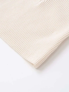 Close-up macro view of high-quality cream white ribbed knit fabric texture and detail