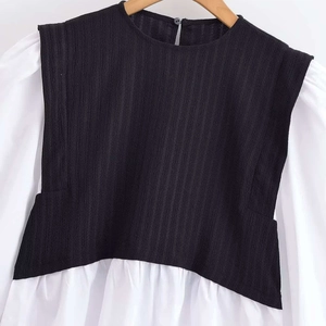Black and white faux two-piece top with textured stripes and puffy long sleeves