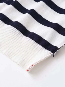 Detail of navy blue and white striped knit fabric with ribbed edge and stitching details