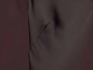 Macro shot of brown chocolate satin fabric with smooth twill texture and silky luster