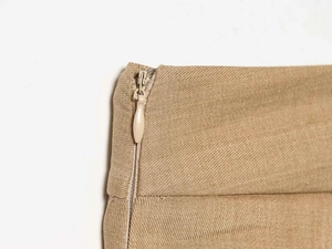 Detail of invisible zipper and twill fabric texture on khaki high waist trousers