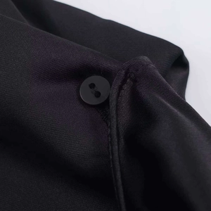 Robe noire asymétrique élégante avec découpe au col montant et bouton mat détaillé