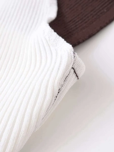 Detailed close-up showing the premium rib-knit texture and stitching of the slim white tank top