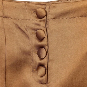 Minimalist golden brown satin high waist wide leg trousers with silk texture and buttons