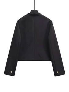 Detail showing the back view of a black tailored jacket with gold metal button accents