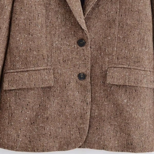 Classic vintage brown tweed blazer with herringbone pattern and two button closure