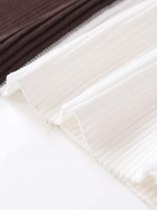 Detail shot of slim fit ribbed knit fabric in dark brown and off-white contrast