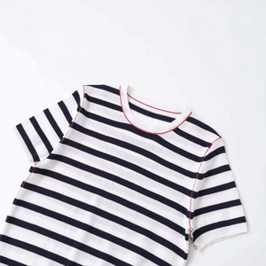 Classic black and white striped knit top with contrasting red stitching on neckline