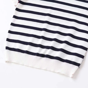 Classic navy and white striped knit sweater with ribbed hem on white background