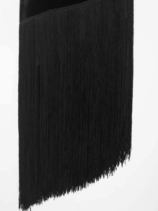 Close-up of high-quality dense black tassels and stitching on a velvet dress hem