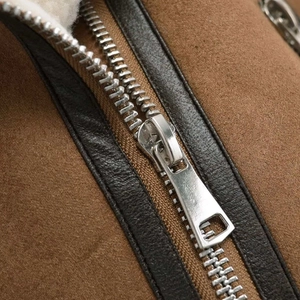 Brown faux suede vest with white faux shearling lining and silver zipper closure details