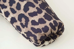 Close-up of leopard print puffer jacket featuring elastic cuffs and soft winter fabric