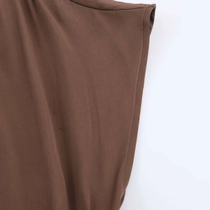 Close-up of dark brown midi dress fabric showing twill texture and neat stitching details