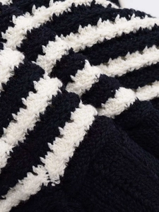 Close-up of black and white striped knit fabric showing soft texture and premium quality