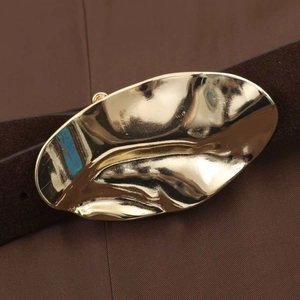 Brown suede belt with unique gold leaf-shaped metal buckle and rich texture
