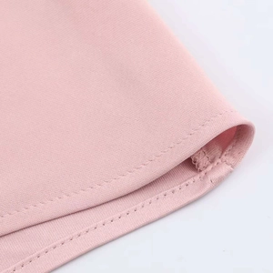 Detailaufnahme des rosa Satinstoffs mit feinen Nähten und glatter Textur für Damen