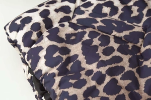 Close-up of leopard print quilted fabric detail with high-quality stitching texture