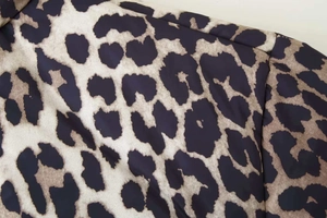 Detailed macro view of high-quality leopard print fabric on padded winter cotton jacket