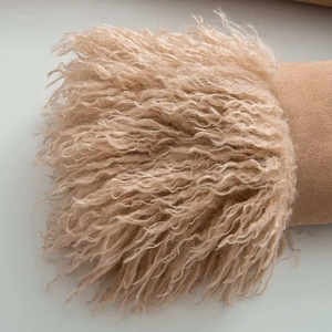 Detailed macro view showing the soft faux fur texture and suede stitching of the winter coat