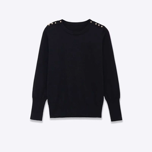 Women's black crew neck knit sweater featuring elegant gold buttons on shoulders