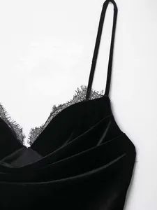 Detail of black velvet camisole top featuring delicate eyelash lace trim and thin straps