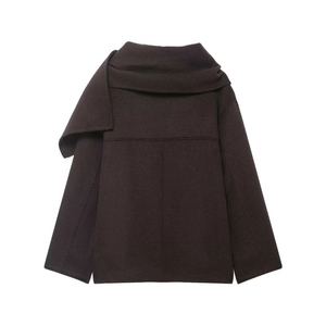 Detail view of the wide asymmetric draped scarf collar on a dark brown wool coat