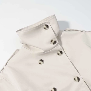 Classic cream double-breasted trench coat featuring high collar and tortoiseshell buttons