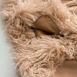 Close-up detail of plush camel faux fur texture and smooth inner lining on winter coat
