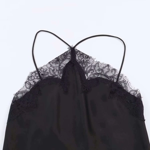 Detail of elegant black satin camisole with delicate eyelash lace trim and thin straps