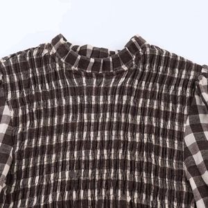Detail view of the retro brown gingham blouse showing smocked bodice and frill collar
