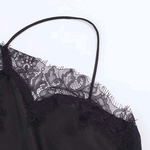 Detail of eyelash lace trim and thin straps on black satin halter maxi dress