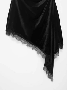 Detailed macro shot of asymmetrical black satin hem with exquisite eyelash lace trim