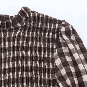 Detail of vintage brown plaid shirt with smocked chest and pleated stand-up collar design