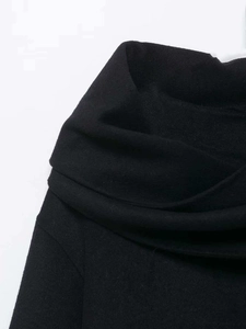 Detail of elegant black wool coat featuring a stylish draped cowl neck design and rich texture