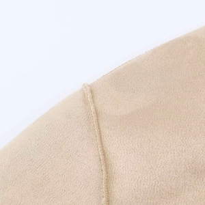 Gedetailleerde close-up van stiksels op beige imitatieleren jas met textuurafwerking