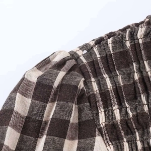 Macro shot of brown and white checkered fabric with detailed elastic shirring technique