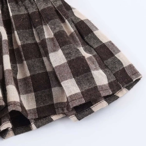 Macro shot of brown and beige plaid pattern with fine pleat texture on vintage shirt fabric