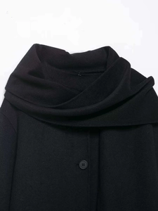 Detail of creative wrap scarf collar on black wool blend minimalist winter coat