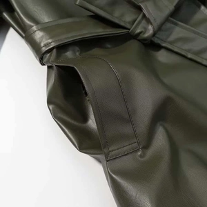 Detailed view of dark olive PU leather coat showing pocket and belt loop stitching