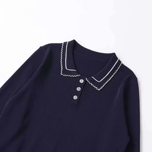 Navy blue knit sweater featuring polo collar with white contrast stitching and buttons