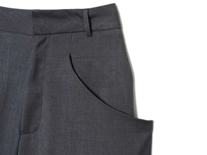 Detail shot of the waistband, belt loops, and side pockets on charcoal grey dress pants