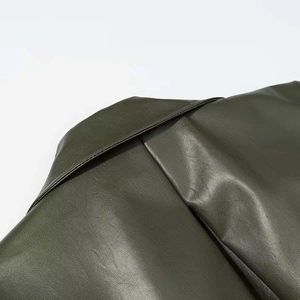 Detailed close-up showing the collar and shoulder stitching of the dark olive leather jacket
