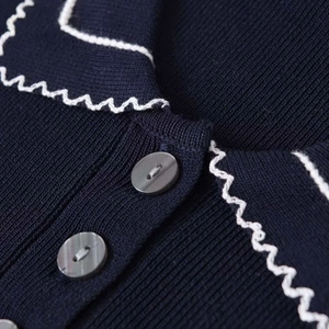 Navy blue ribbed knit cardigan with white scallop lace trim and button detail