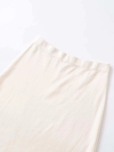 Detailed close-up of beige knitted skirt waist with high-quality elastic waistband