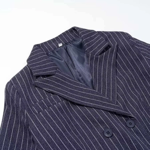 Classic dark blue pinstripe blazer featuring a notch lapel and fine woven wool texture