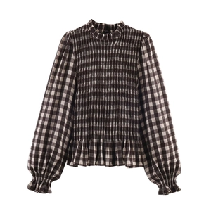Women's black and white gingham shirt with smocked chest detail and ruffled hem
