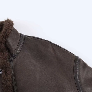 Close-up of vintage dark brown faux leather bomber jacket with thick fur collar and stitching