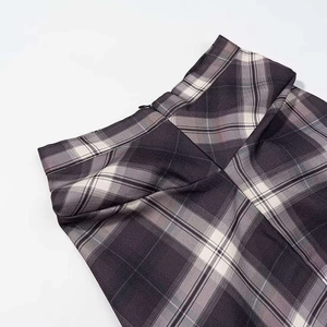 Detail view of the hidden zipper and waistband on this gray and purple plaid skirt